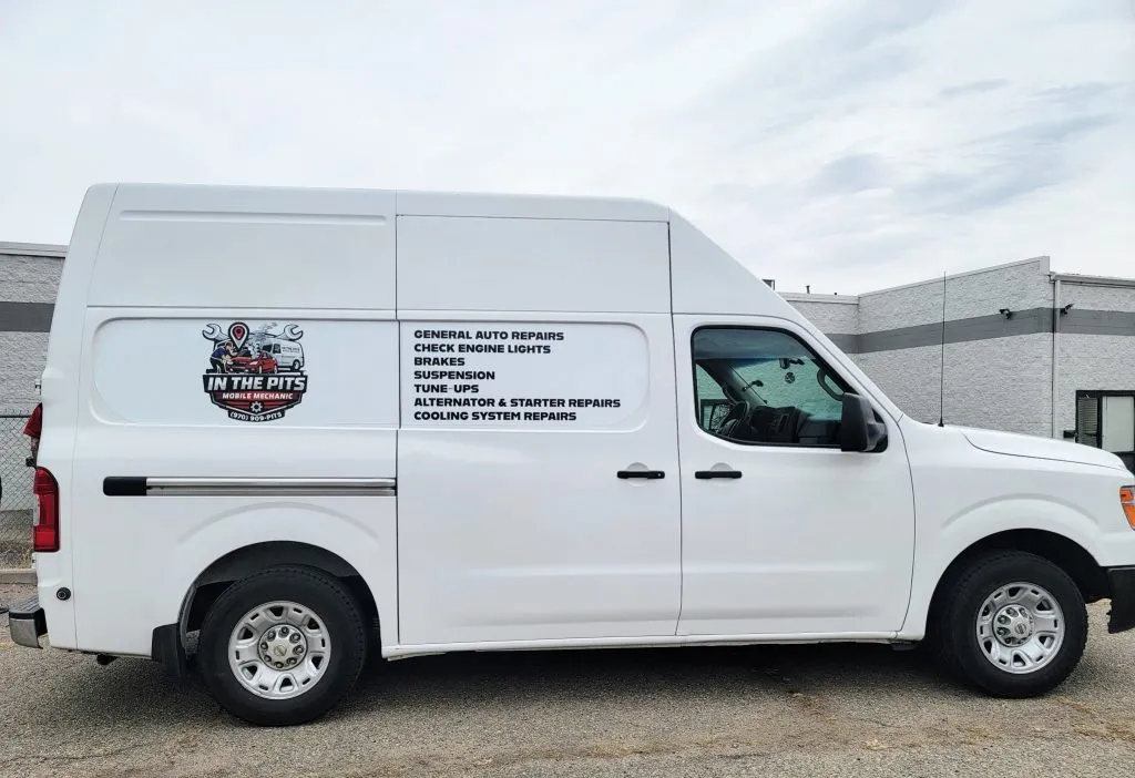 The white In The Pits service van, lettered with the logo and the full list of services